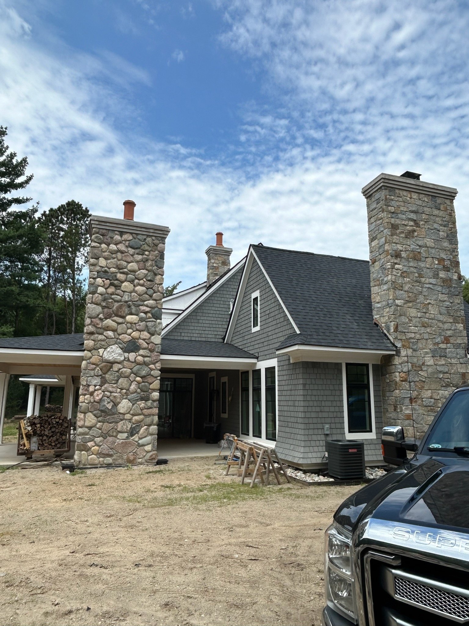 Two stone chimneys on new construction home